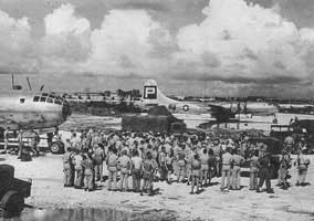 B-29 bombers of the 509th Composite Group on Tinian with an assembly of military and Project Alberta technical personnel before the bombing of Hiroshima. 
