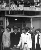 4 glum Beatles arriving back at 