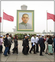 Crowds walking past portrait of Sun Yat-sen to view wax image of Mao. 