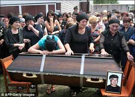Family and friends of an Ossetian killed in the fighting in Tskhinvali weep at his funeral today