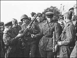 A U.S. soldier demonstrates the use of the M-1 rifle to his curious Red Army comrades. 