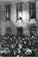 Adolf Hitler waving to an adoring crowd in Berlin .