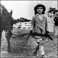 A determined 5-year-old Jackie leading her pony at the Smithtown, Long Island, Riding Club.