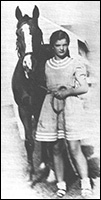 Jackie as a physically fit teenager leading her horse Danseuse from the stables at Lasata. 