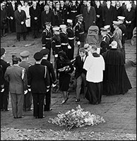 Mrs. Kennedy praying for the soul of her dead husband at the graveside.