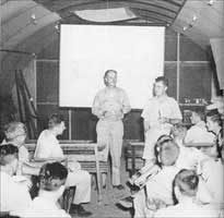 Commodore Parsons and Colonel Paul Tibbets briefing crews for the Hiroshima mission. 