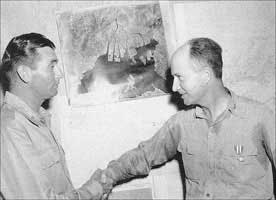 Commodore Deak Parsons (right) was awarded the Silver Star by the Army Strategic Air Forces while still wearing the shirt stained by sweat and blackened by graphite from his making the final assembly of the bomb during the Enola Gay's flight to Hiroshima.