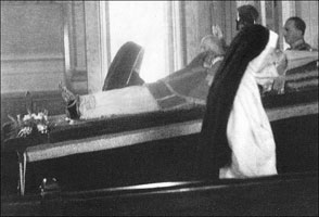 The nun by the window is "La Popessa" shedding crocodile tears for Pius XII. 