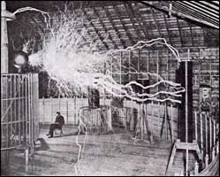 Tesla with his magnifying transmitter producing millions of volts of electricity. 